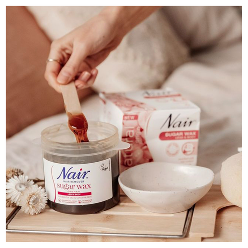 A person applying Nair Sugar Wax 508g